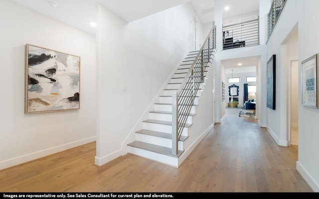 2706 Obsidian Dr, Rosharon, TX 77583 - staircase with wood finished floors, baseboards, a high ceiling, and recessed lighting