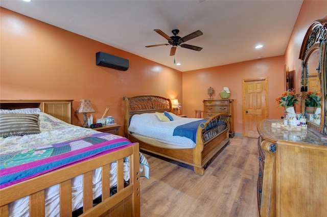 120 Rebecca St, Houston, TX 77022 - bedroom featuring a wall unit AC, light wood-type flooring, recessed lighting, and ceiling fan