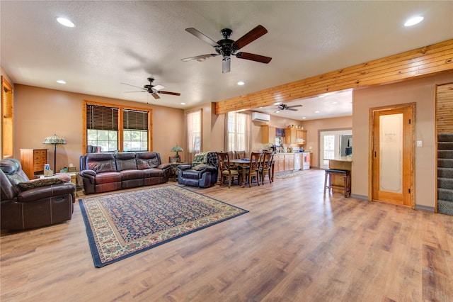 120 Rebecca St, Houston, TX 77022 - living area with recessed lighting, a wall unit AC, ceiling fan, light wood-type flooring, and stairway