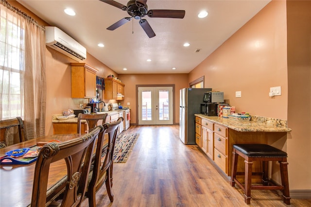 120 Rebecca St, Houston, TX 77022 - kitchen featuring white gas stove, freestanding refrigerator, french doors, light wood finished floors, and a ceiling fan