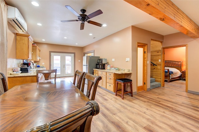 120 Rebecca St, Houston, TX 77022 - dining space with an AC wall unit, french doors, light wood-type flooring, stairway, and a ceiling fan