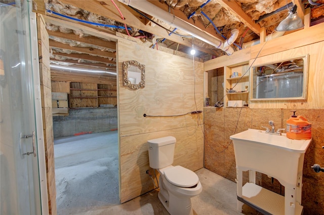 120 Rebecca St, Houston, TX 77022 - bathroom with concrete flooring, toilet, and a sink
