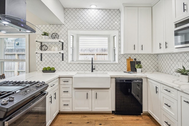 1411 Tulane St, Houston, TX 77008 - kitchen with black appliances, a sink, ventilation hood, white cabinets, and light wood-style flooring