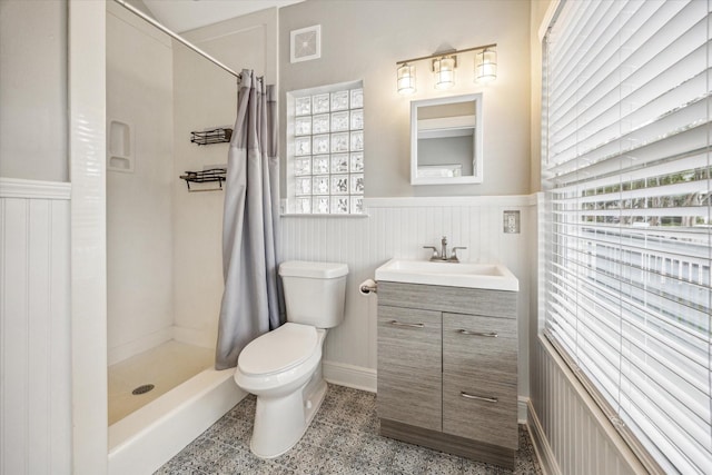 1411 Tulane St, Houston, TX 77008 - bathroom featuring wainscoting, a stall shower, toilet, healthy amount of natural light, and vanity