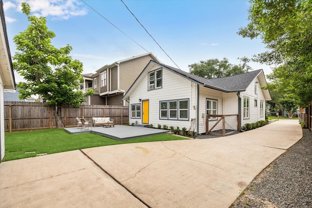 1411 Tulane St, Houston, TX 77008 - back of property featuring outdoor lounge area, a patio, and a shingled roof