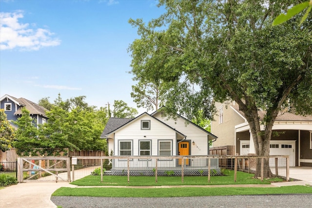 1411 Tulane St, Houston, TX 77008 - view of front of home featuring a garage, a gate, and a shingled roof
