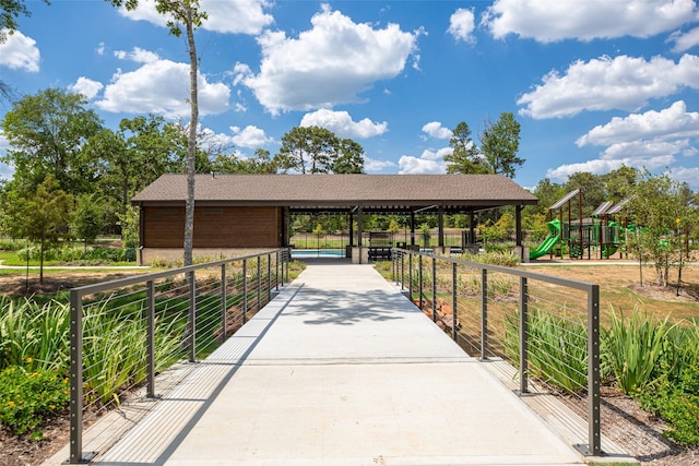 view of home's community with a gazebo, playground community, and fence