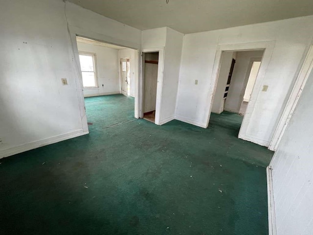 carpeted spare room with baseboards