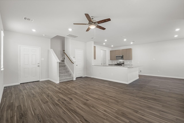 unfurnished living room featuring stairway, a ceiling fan, dark wood-type flooring, and recessed lighting