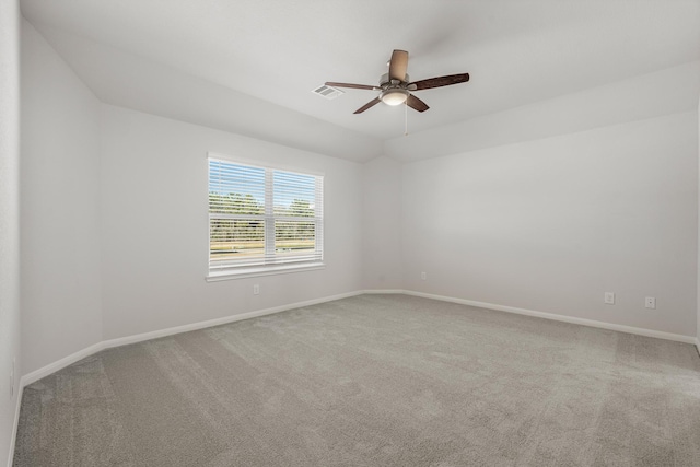 carpeted empty room featuring baseboards, ceiling fan, and visible vents