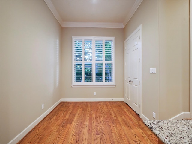 unfurnished bedroom featuring ornamental molding, baseboards, and light wood-style floors
