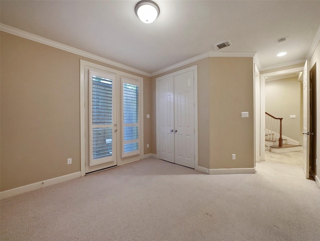 unfurnished bedroom featuring baseboards, ornamental molding, light colored carpet, and access to exterior