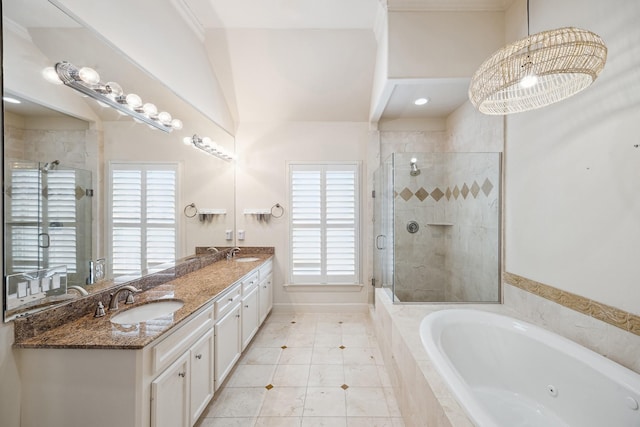full bathroom with double vanity, a whirlpool tub, a stall shower, and a sink