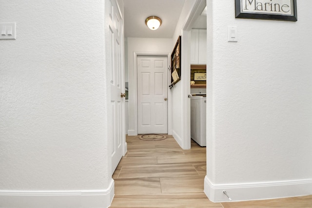 11202 Leah Elizabeth Dr, Needville, TX 77461 - hall featuring a textured wall, light wood-style floors, washer / dryer, and baseboards