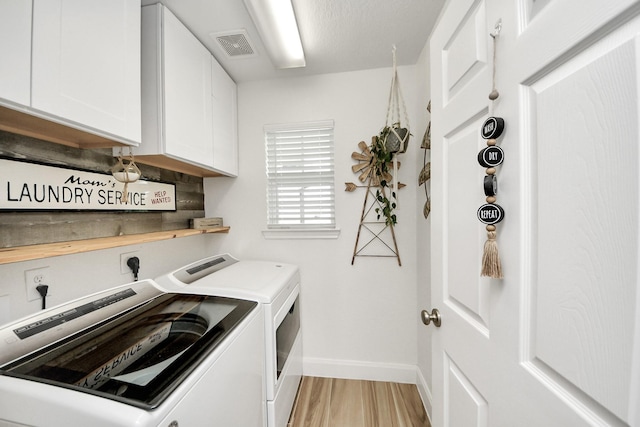 11202 Leah Elizabeth Dr, Needville, TX 77461 - laundry room with washer and clothes dryer, cabinet space, baseboards, and light wood-style flooring