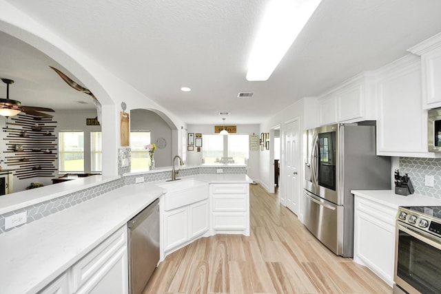 11202 Leah Elizabeth Dr, Needville, TX 77461 - kitchen featuring a sink, appliances with stainless steel finishes, tasteful backsplash, light countertops, and recessed lighting