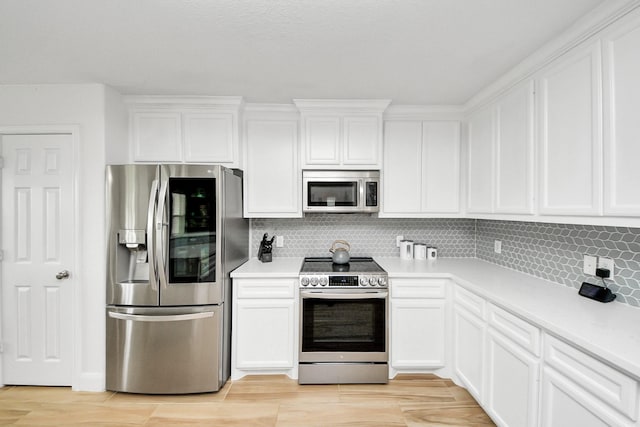 11202 Leah Elizabeth Dr, Needville, TX 77461 - kitchen with appliances with stainless steel finishes, white cabinets, decorative backsplash, and light countertops