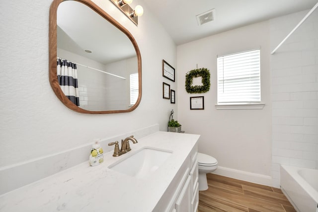 11202 Leah Elizabeth Dr, Needville, TX 77461 - full bathroom featuring wood finished floors, toilet, baseboards, vanity, and shower / tub combo