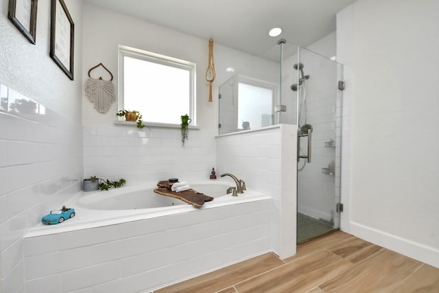 11202 Leah Elizabeth Dr, Needville, TX 77461 - bathroom featuring a bath, a stall shower, and wood finished floors