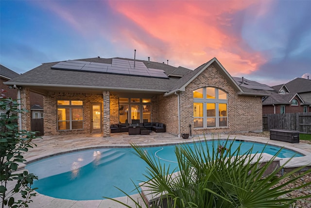 17019 Mahogany Trace Ln, Richmond, TX 77407 - pool at dusk with an outdoor living space, a patio, a fenced in pool, and fence