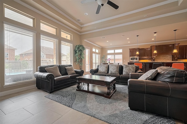 17019 Mahogany Trace Ln, Richmond, TX 77407 - living area featuring light tile patterned floors, baseboards, ornamental molding, visible vents, and ceiling fan