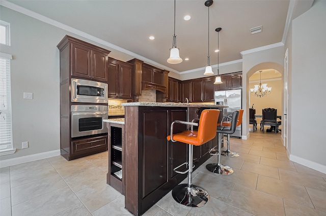 17019 Mahogany Trace Ln, Richmond, TX 77407 - kitchen with stainless steel appliances, visible vents, dark brown cabinetry, crown molding, and decorative backsplash