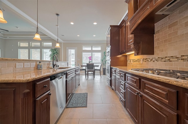 17019 Mahogany Trace Ln, Richmond, TX 77407 - kitchen with ornamental molding, a sink, premium range hood, backsplash, and appliances with stainless steel finishes