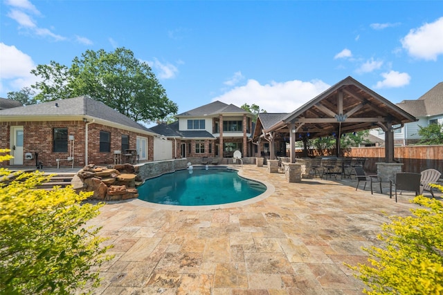 view of pool featuring outdoor dry bar, a patio area, and a fenced in pool