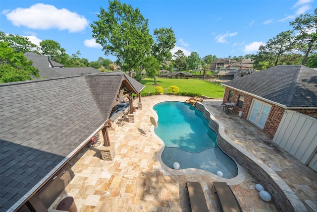outdoor pool featuring a yard, a patio area, fence private yard, and french doors