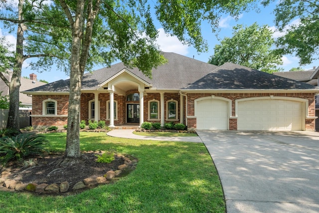 view of front of property with driveway, brick siding, fence, a garage, and a front lawn