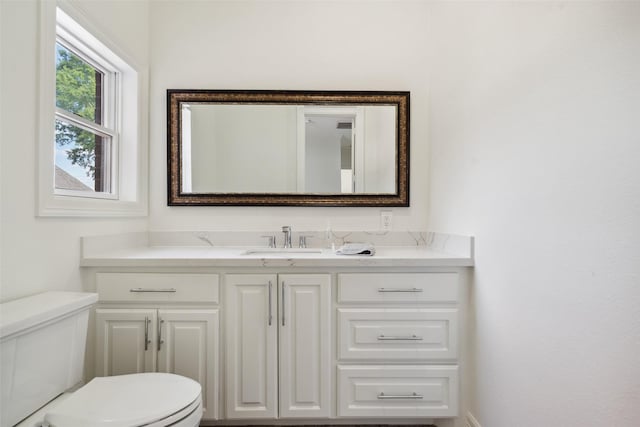 half bathroom featuring toilet and vanity