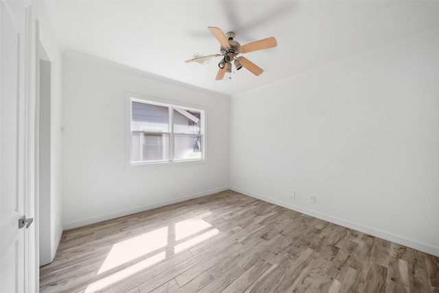 unfurnished room with light wood finished floors, baseboards, a ceiling fan, and ornamental molding