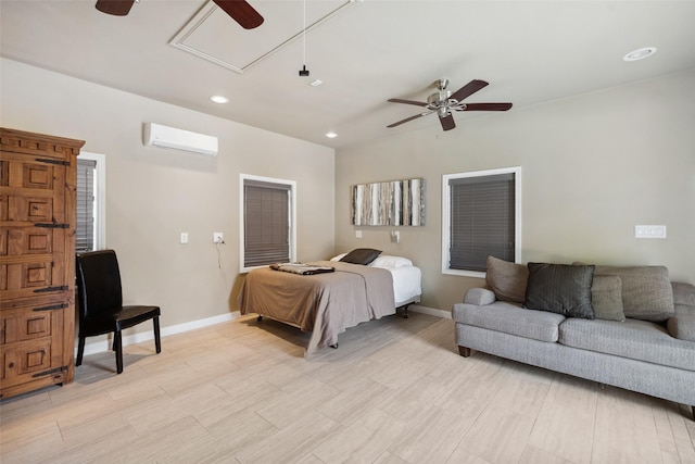 bedroom featuring recessed lighting, attic access, a wall mounted AC, baseboards, and light wood-style floors