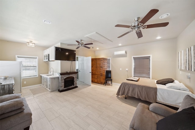 bedroom with a sink, attic access, baseboards, a wall mounted AC, and recessed lighting