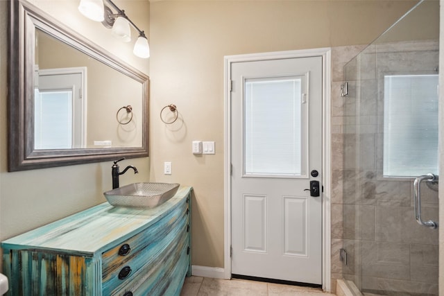 full bath with vanity, baseboards, tile patterned flooring, and a shower stall