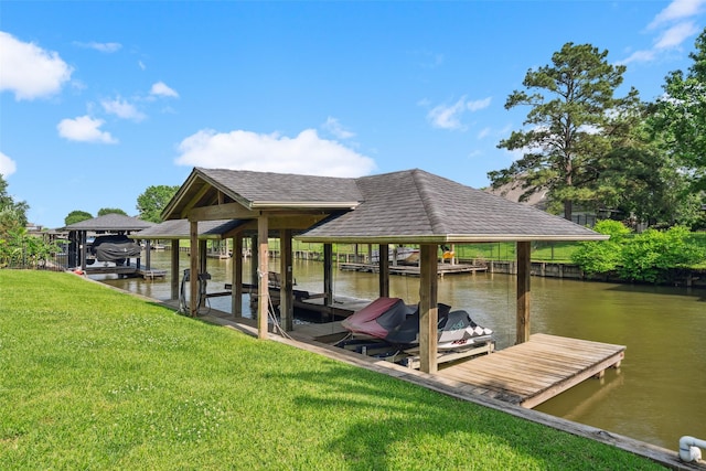 view of dock with a water view, boat lift, and a lawn