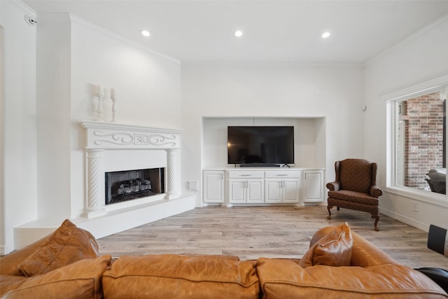 living area featuring ornamental molding, recessed lighting, and light wood-style floors