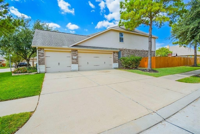 view of side of home featuring brick siding, fence, concrete driveway, and a lawn