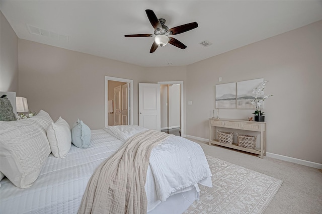 carpeted bedroom featuring baseboards, visible vents, and a ceiling fan