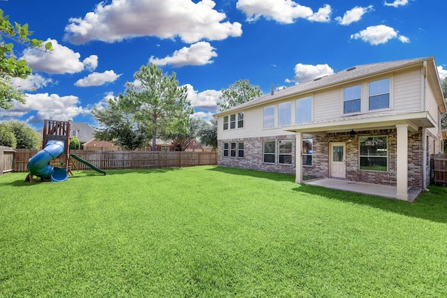 back of property with a playground, a patio area, and a fenced backyard
