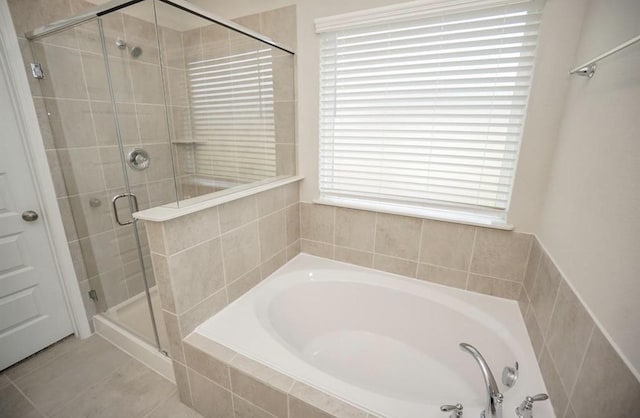 full bath with a shower stall and a garden tub