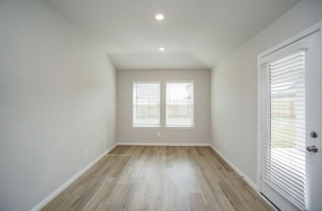 spare room with baseboards, light wood-style flooring, and recessed lighting