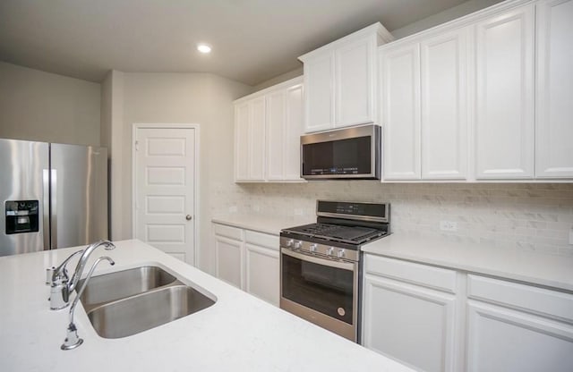 kitchen with light countertops, stainless steel appliances, and a sink