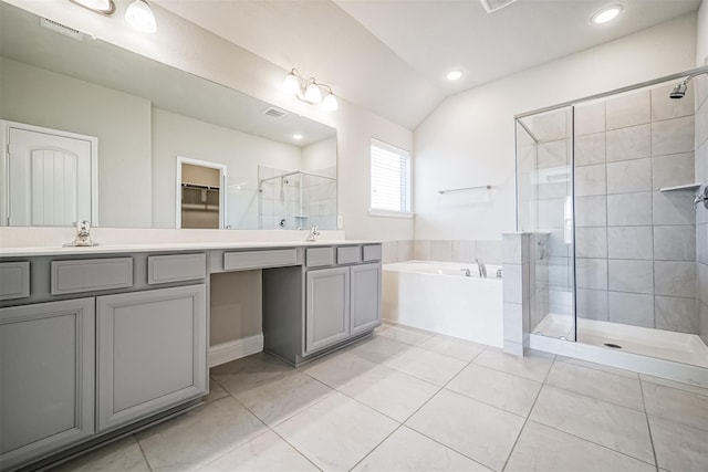 full bath featuring a shower stall, tile patterned floors, a bath, and vaulted ceiling