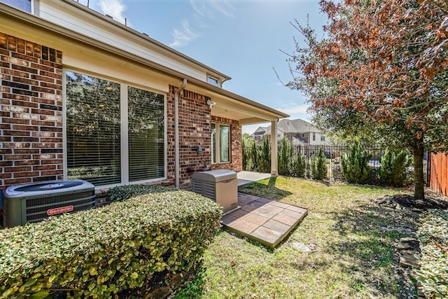 view of yard with central AC, a patio area, and a fenced backyard