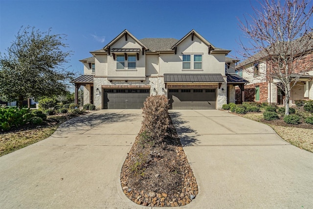 view of front facade with a standing seam roof, an attached garage, stucco siding, concrete driveway, and stone siding