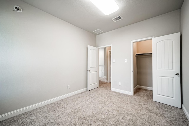 unfurnished bedroom featuring carpet flooring, baseboards, and visible vents