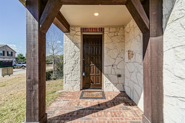 property entrance featuring stone siding