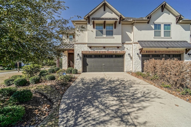view of property featuring stone siding, stucco siding, driveway, and a garage