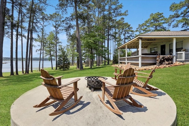 view of patio featuring a water view and a fire pit